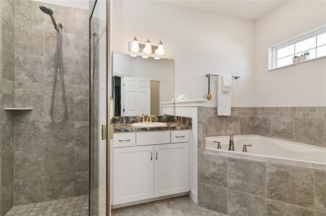 bathroom featuring vanity and independent shower and bath