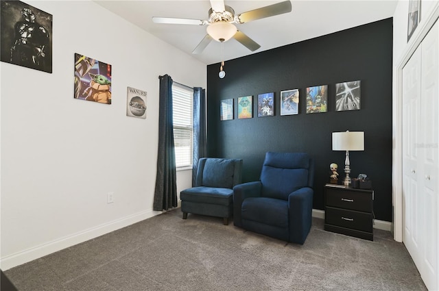 living area with ceiling fan and carpet flooring