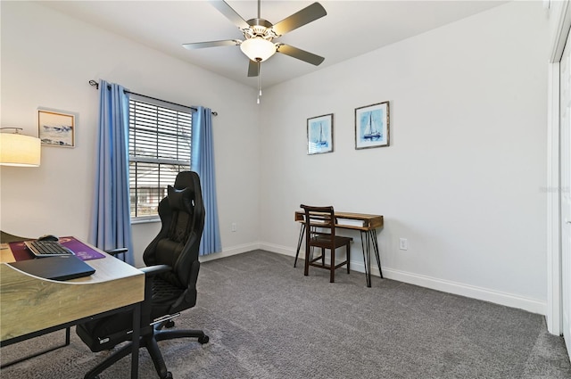 carpeted office space featuring ceiling fan