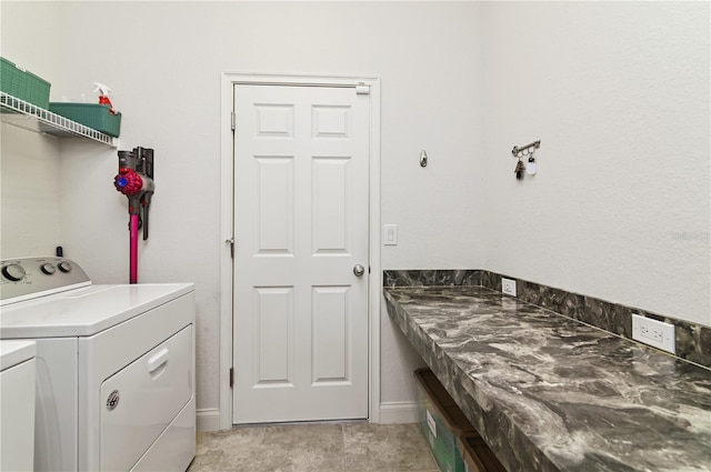 clothes washing area featuring washer and clothes dryer