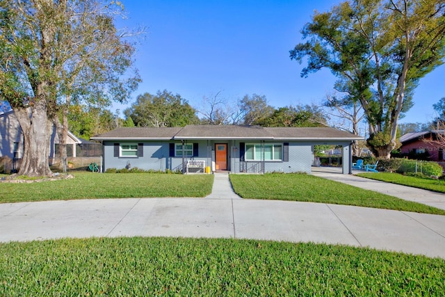 ranch-style house featuring a front lawn and a carport