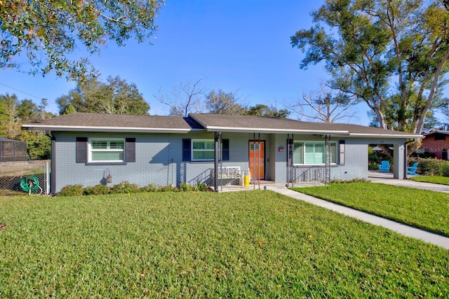 ranch-style house with a carport, a porch, and a front lawn