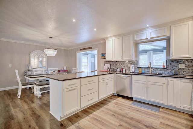 kitchen with dishwasher, pendant lighting, white cabinets, and kitchen peninsula