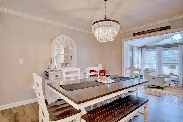 dining room featuring ornamental molding, a notable chandelier, and light hardwood / wood-style floors