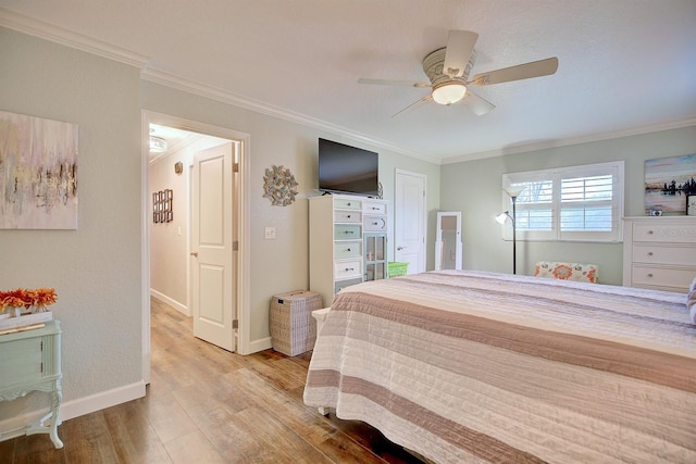 bedroom with crown molding, ceiling fan, and light hardwood / wood-style flooring