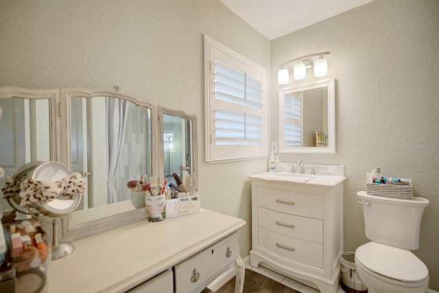 bathroom featuring vanity and toilet