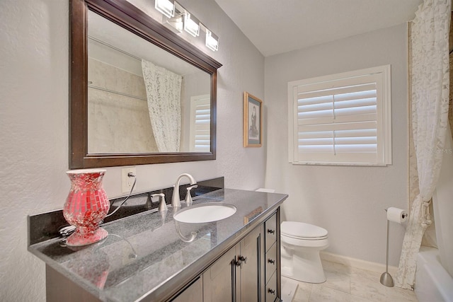 full bathroom with vanity, shower / tub combo, and toilet