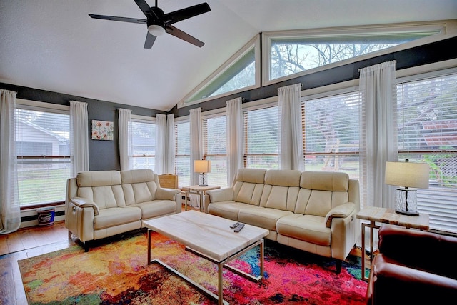 sunroom / solarium featuring ceiling fan, vaulted ceiling, and a healthy amount of sunlight