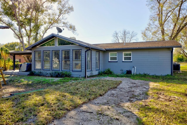 back of house featuring a yard