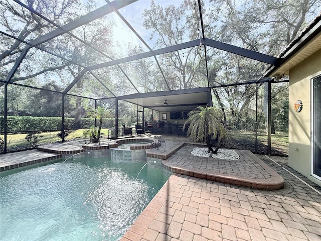 view of pool featuring a lanai, an outdoor bar, a patio area, pool water feature, and an in ground hot tub