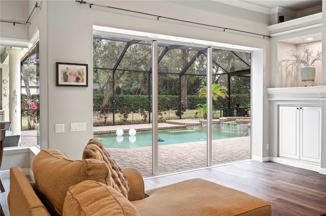 doorway to outside with hardwood / wood-style flooring and ornamental molding