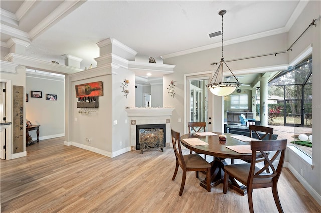 dining room featuring ornamental molding and light wood-type flooring