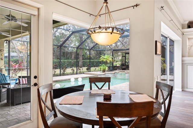 dining space with wood-type flooring and ornamental molding