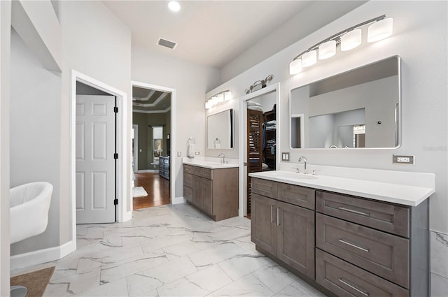 bathroom with vanity and ornamental molding