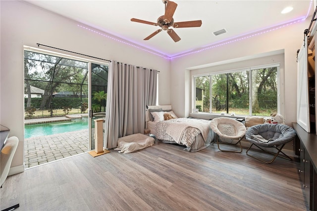 bedroom featuring hardwood / wood-style flooring, access to exterior, and ceiling fan