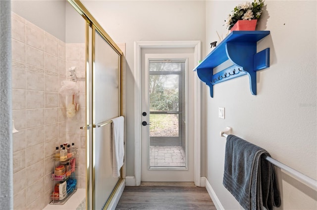 doorway with hardwood / wood-style flooring