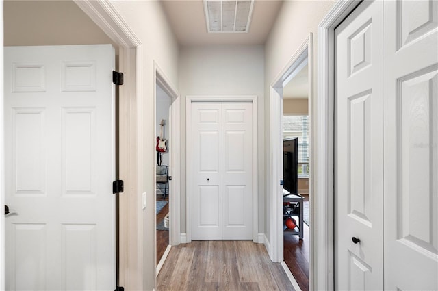 hallway with light wood-type flooring