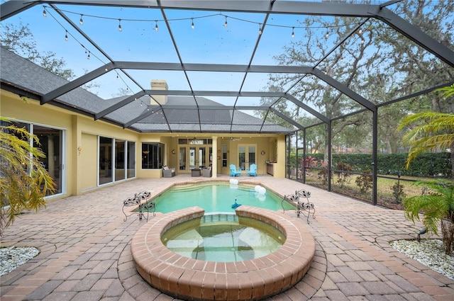 view of swimming pool with a lanai, a patio area, french doors, and an in ground hot tub