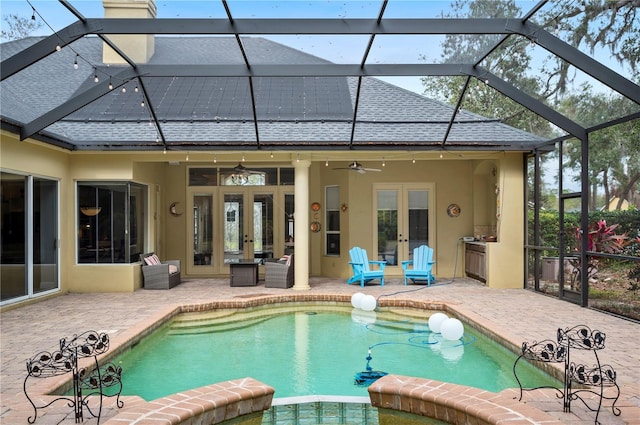 view of pool featuring french doors, ceiling fan, a lanai, and a patio