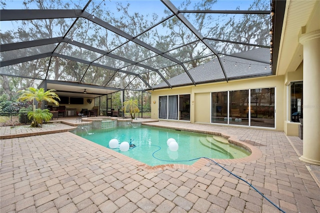 view of swimming pool with an in ground hot tub, a lanai, and a patio