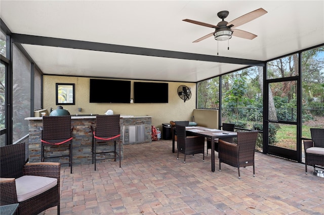 sunroom featuring a wealth of natural light and ceiling fan