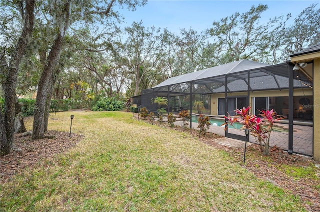 view of yard with a patio and glass enclosure