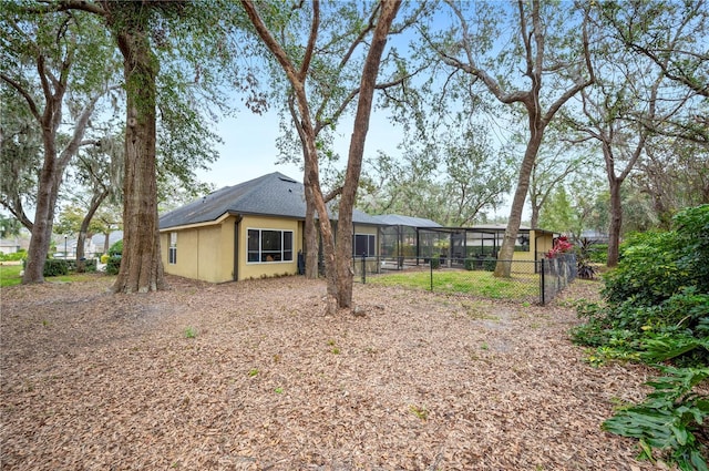 back of house featuring a lanai