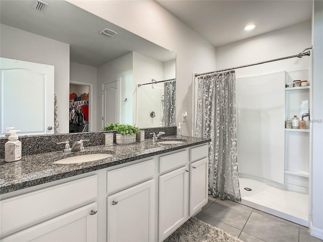 full bath with a stall shower, visible vents, and a sink