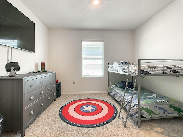 bedroom featuring carpet and baseboards