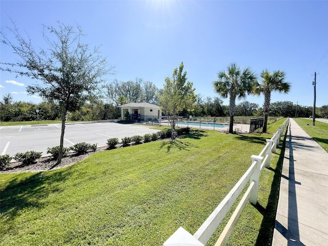 view of yard featuring fence and a fenced in pool