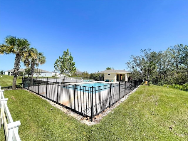 pool with a yard and fence