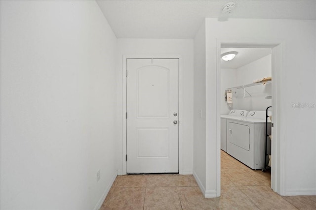 laundry area featuring light tile patterned floors and independent washer and dryer