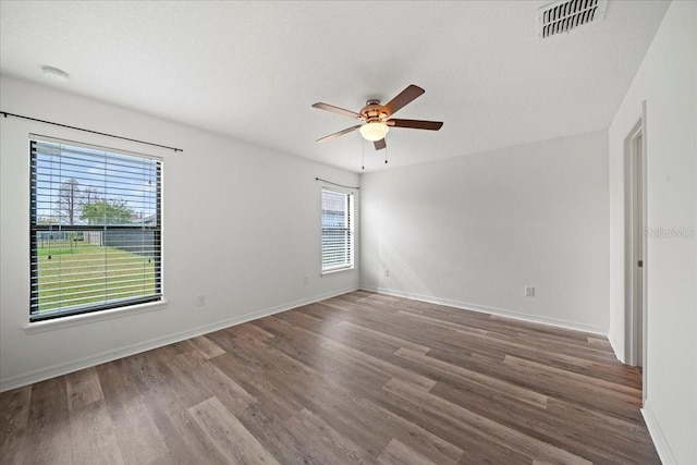 unfurnished room featuring hardwood / wood-style floors, a textured ceiling, and ceiling fan