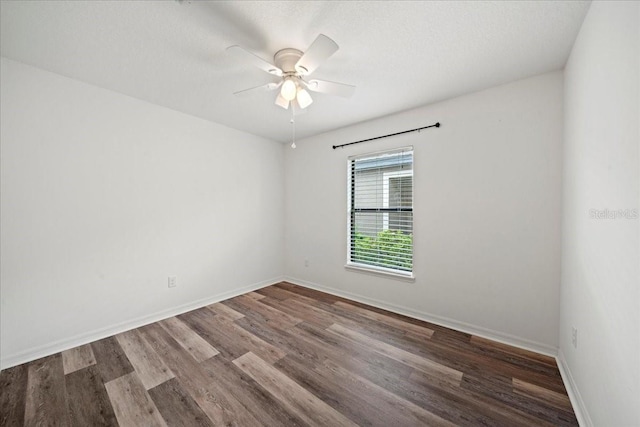 spare room with dark hardwood / wood-style flooring, a textured ceiling, and ceiling fan