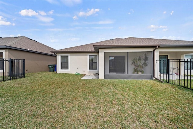 rear view of house with a lawn