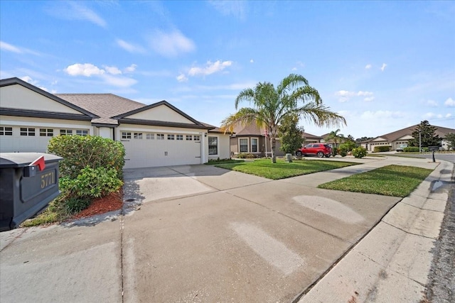 ranch-style house featuring a garage and a front yard