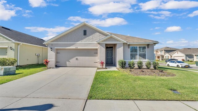 view of front of property featuring a garage, a front lawn, and stucco siding