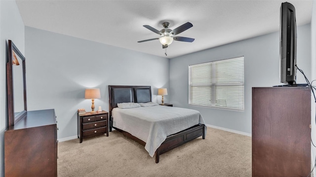 carpeted bedroom featuring ceiling fan and baseboards