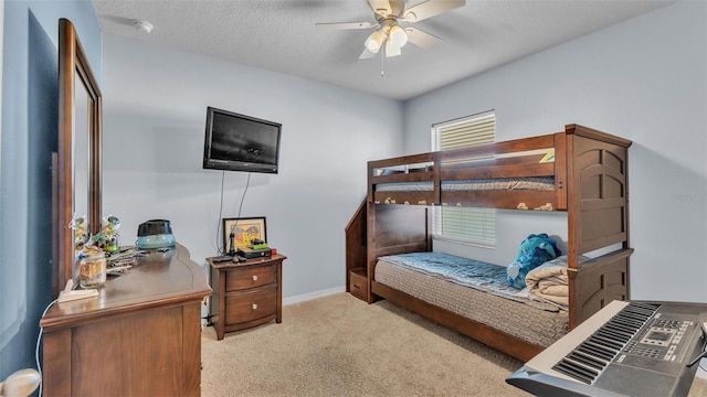 bedroom with a textured ceiling, carpet, and baseboards