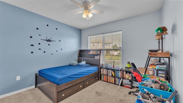 bedroom featuring carpet, baseboards, and a ceiling fan