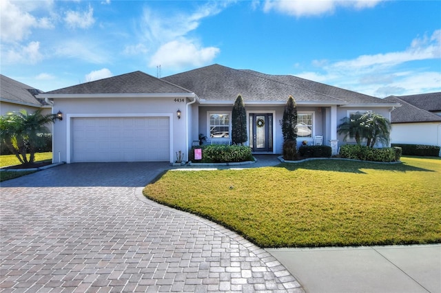 ranch-style house with a garage and a front yard