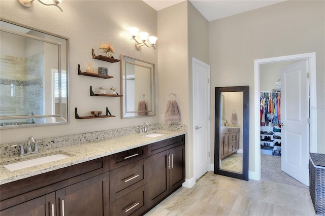 bathroom with a shower with door and vanity