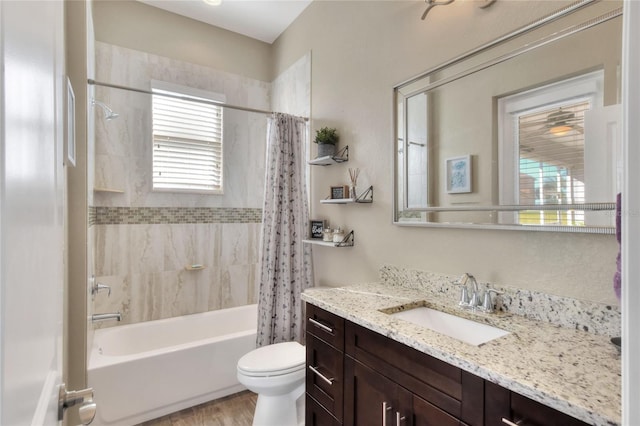 full bathroom with vanity, shower / bath combination with curtain, and toilet