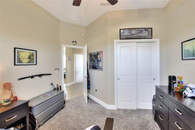 interior space featuring ceiling fan and a closet