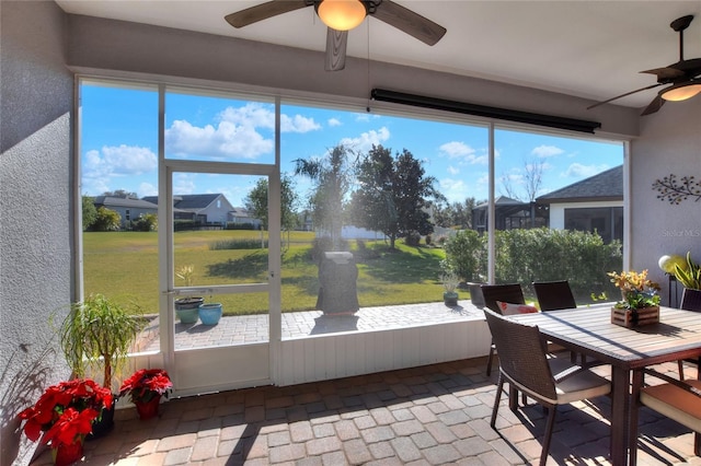 sunroom / solarium with ceiling fan