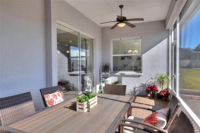 sunroom / solarium featuring ceiling fan