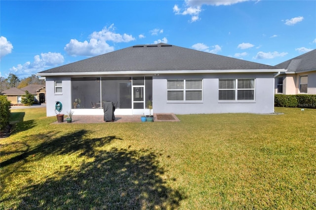 back of property featuring a sunroom and a yard