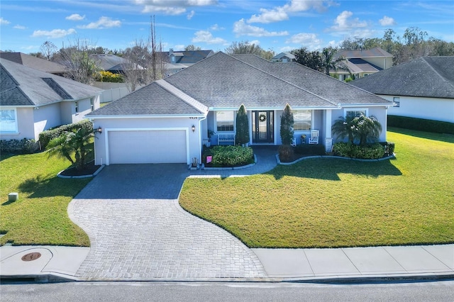 view of front facade featuring a garage and a front lawn