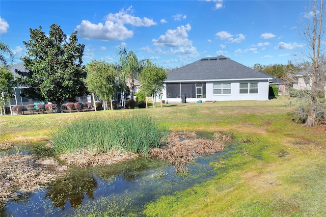 rear view of property featuring a lawn