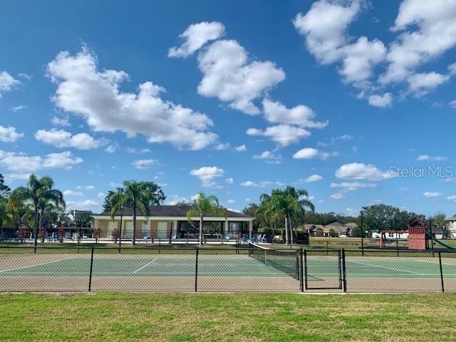 view of sport court with a yard